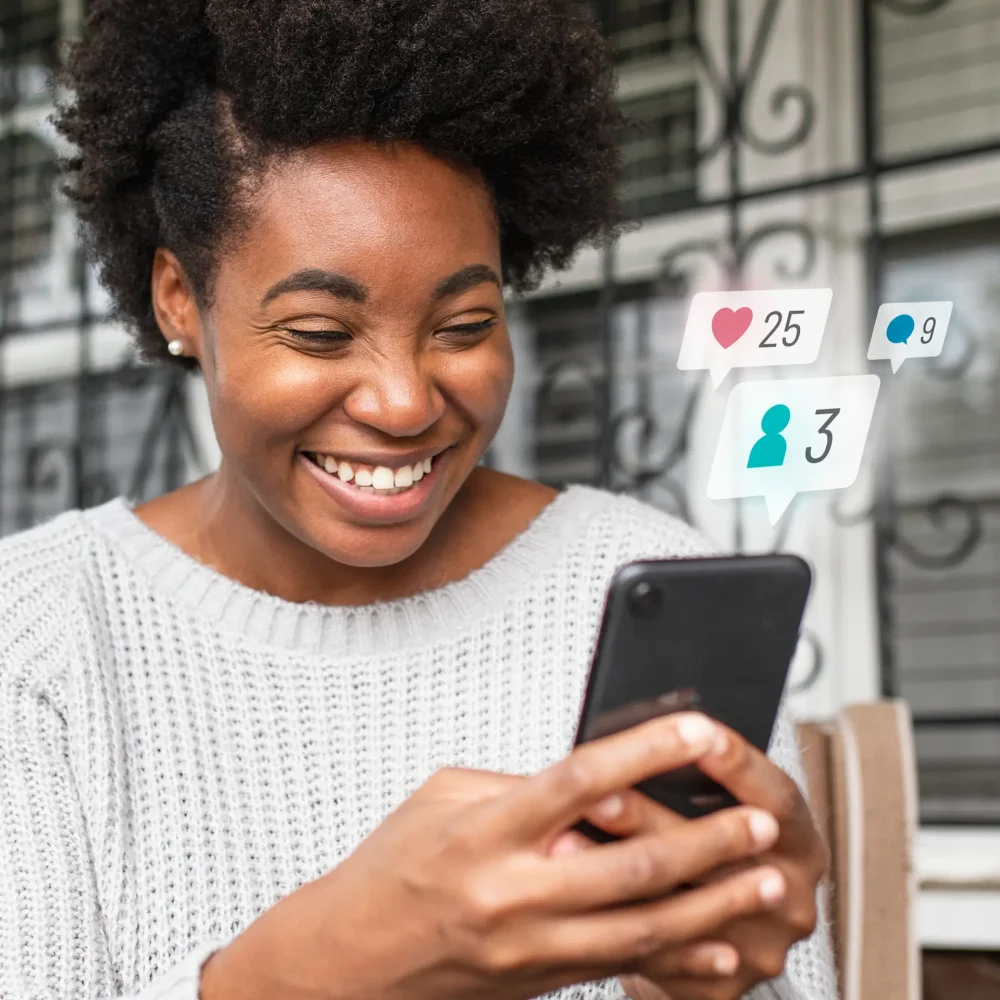 African American woman checking social media on a phone